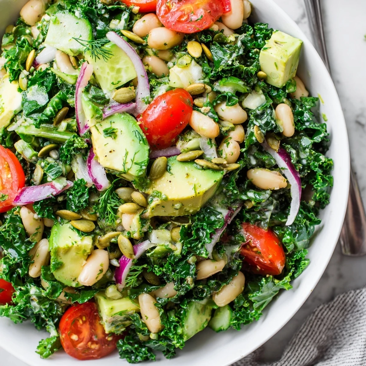 Creamy Avocado White Bean Kale Salad Bowl with Fresh Herbs, zesty lemon tahini drizzle.