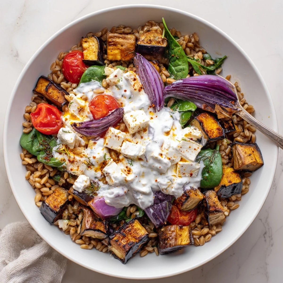 Warm Mediterranean Roasted Eggplant Farro Grain Bowl with Yogurt served with dill