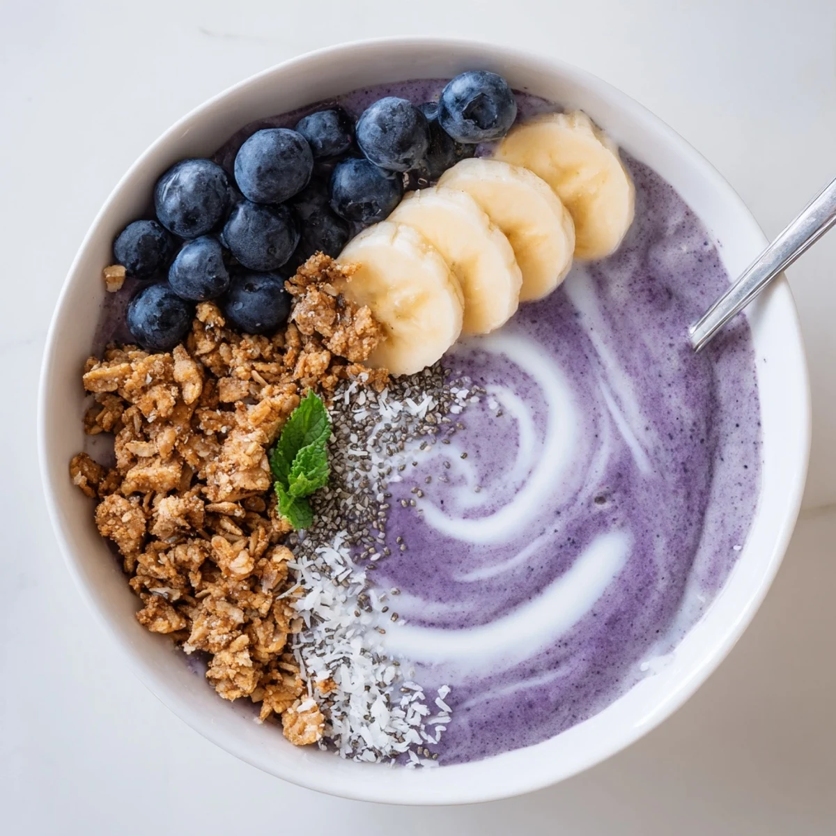 Blueberry Banana Coconut Smoothie Bowl with Granola Clusters, creamy vibrant breakfast bowl