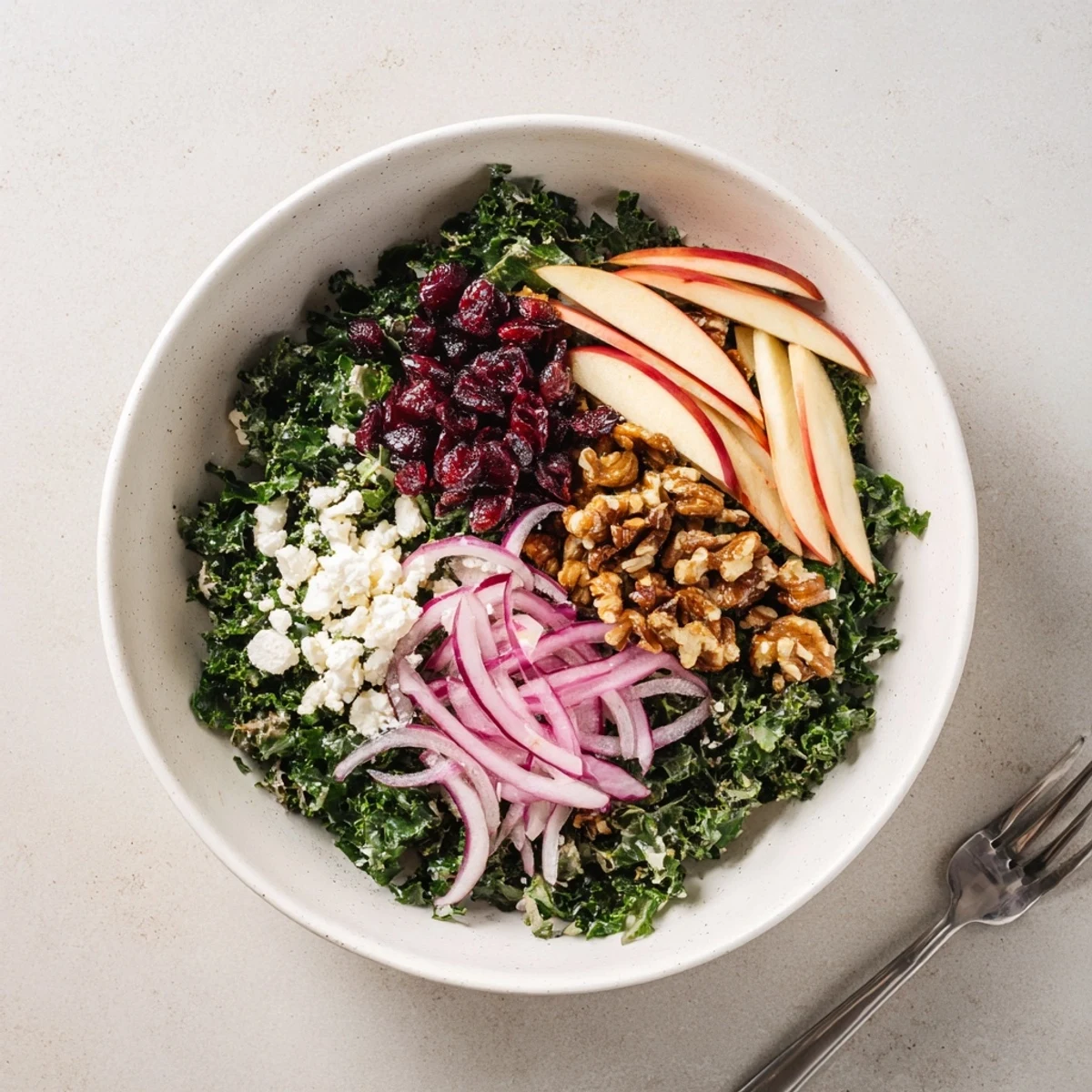 Shaved Kale Apple Walnut Salad Bowl with Maple Dressing, crunchy apples and toasted walnuts.