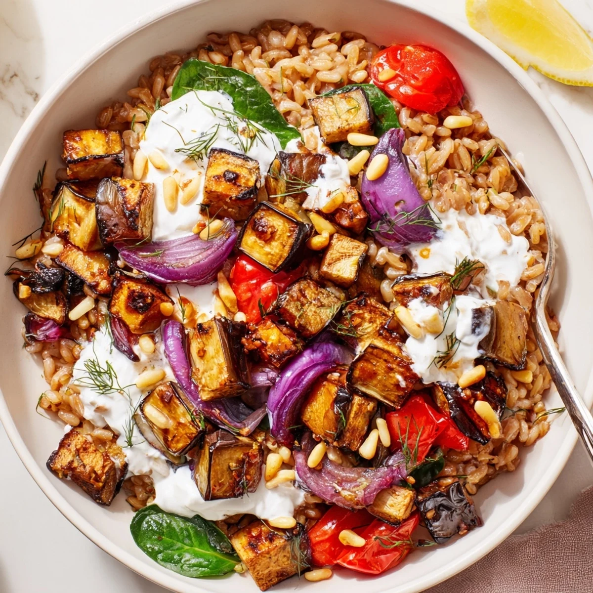 Mediterranean Roasted Eggplant Farro Grain Bowl with Yogurt served warm, creamy dill sauce