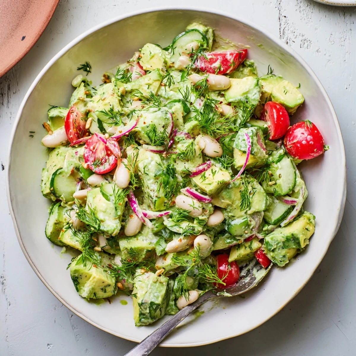 Bright lemon-dressed Creamy Avocado Dill White Bean Salad Bowl with Cucumber, crisp.