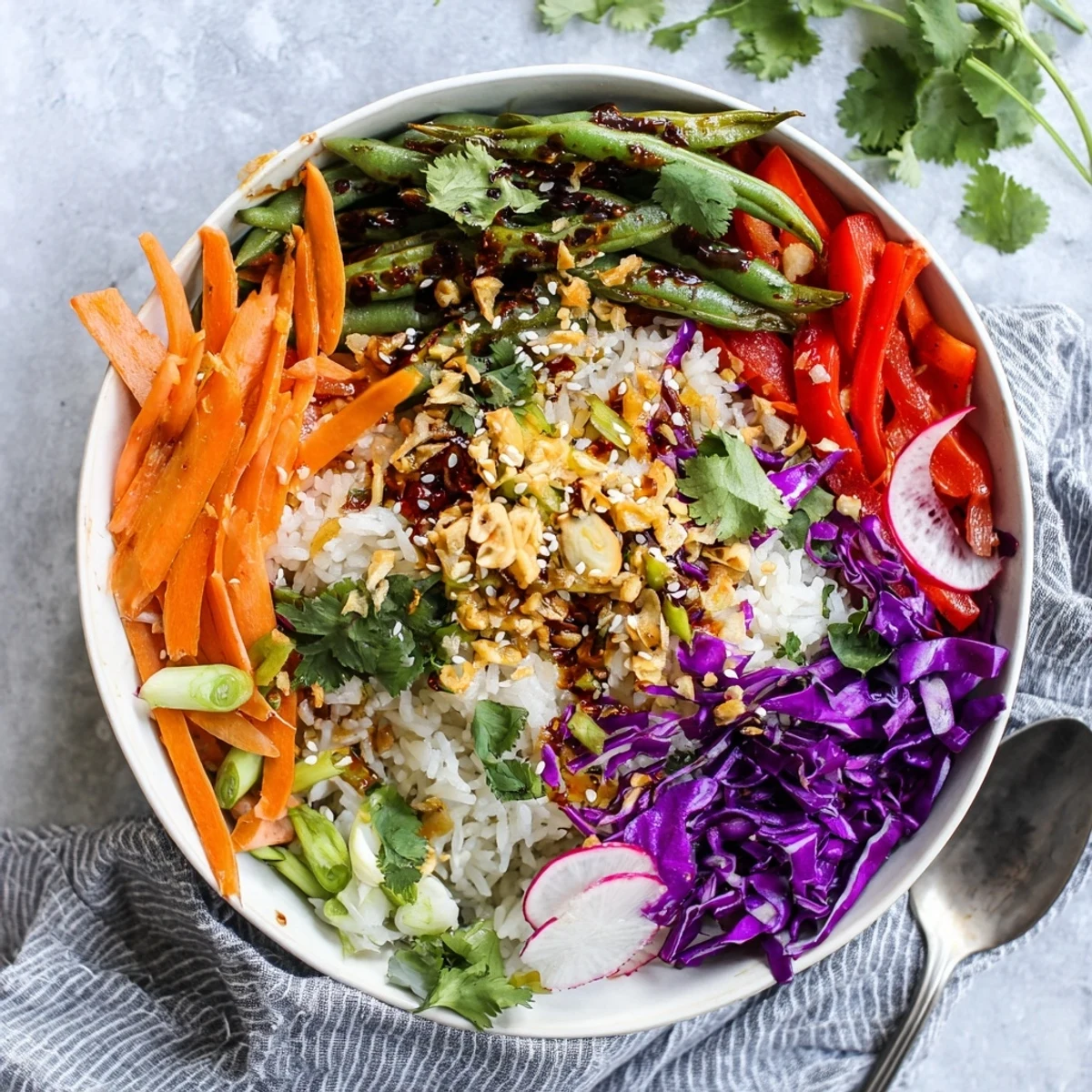 Hearty vegetable bowl with roasted green beans tossed in spicy chili oil dressing and sprinkled with crunchy crispy garlic