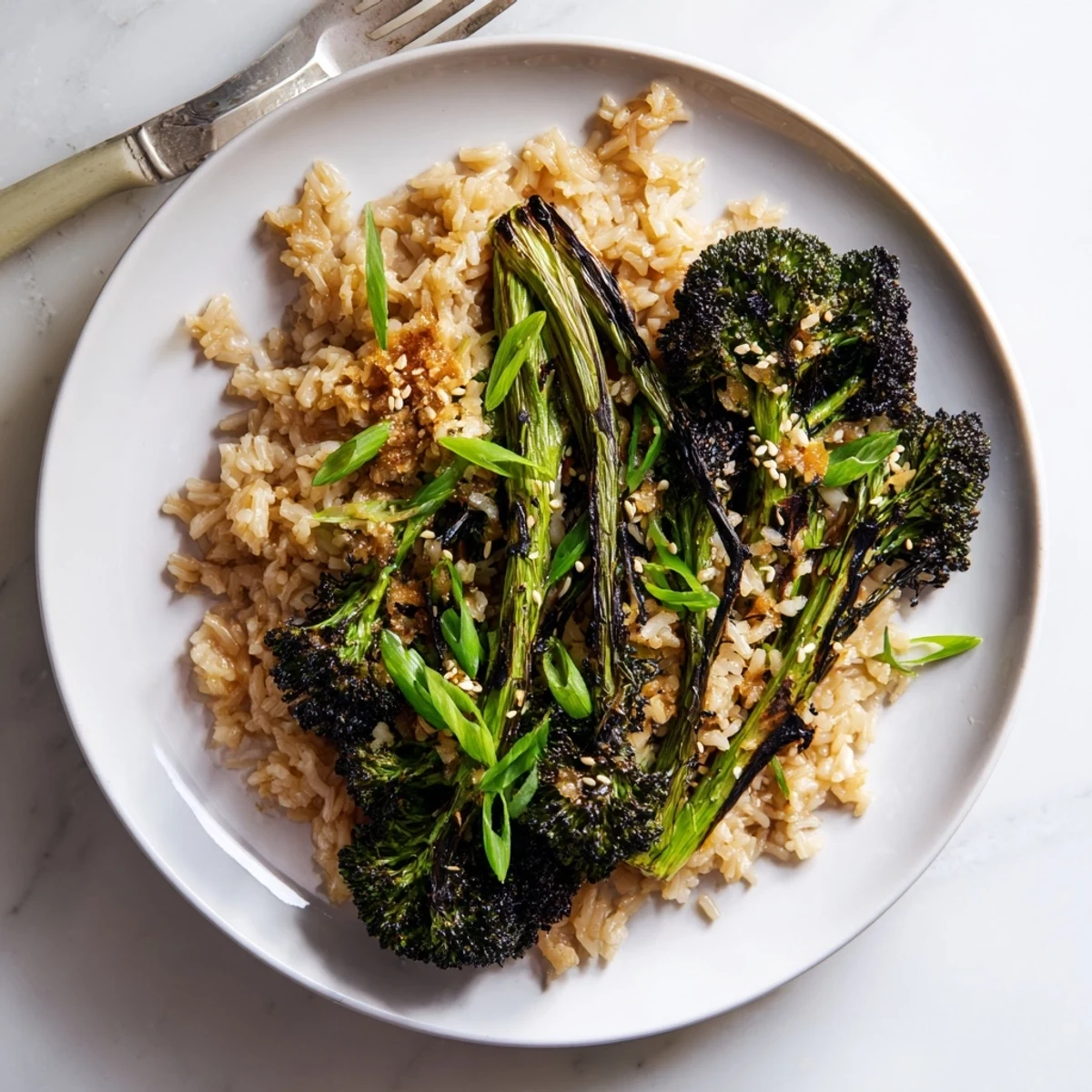 Fluffy jasmine rice infused with aromatic garlic and ginger served alongside crispy charred broccoli