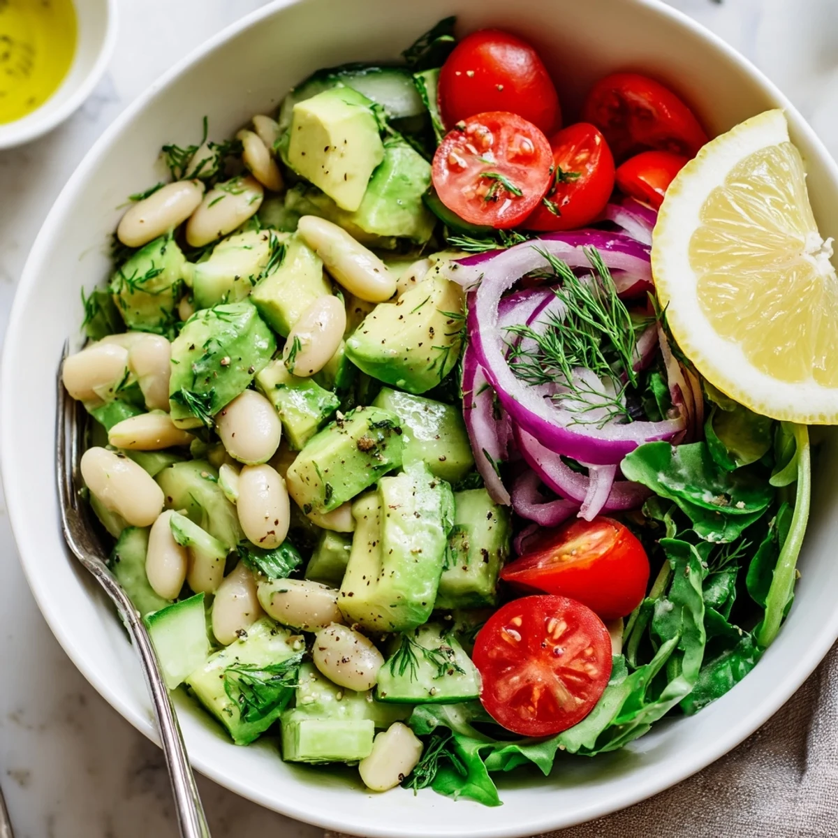 Creamy Avocado Dill White Bean Salad Bowl with Lemon, vibrant colors and zesty dressing.