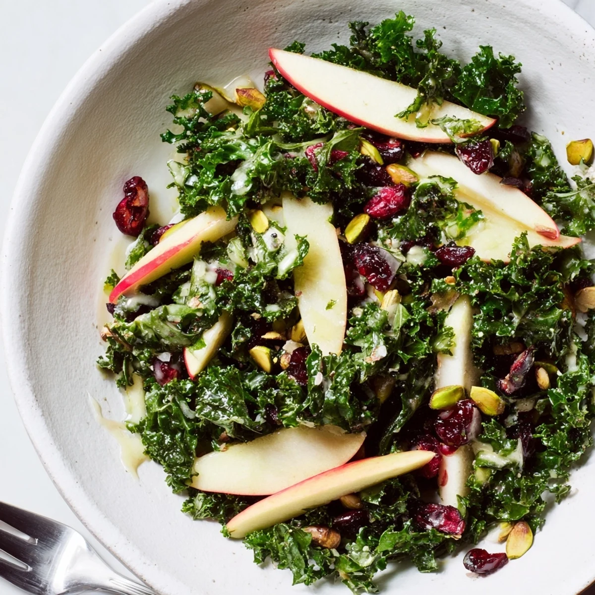 Shaved Kale Apple Pistachio Salad Bowl with Maple Dressing, thin apple slices, maple vinaigrette
