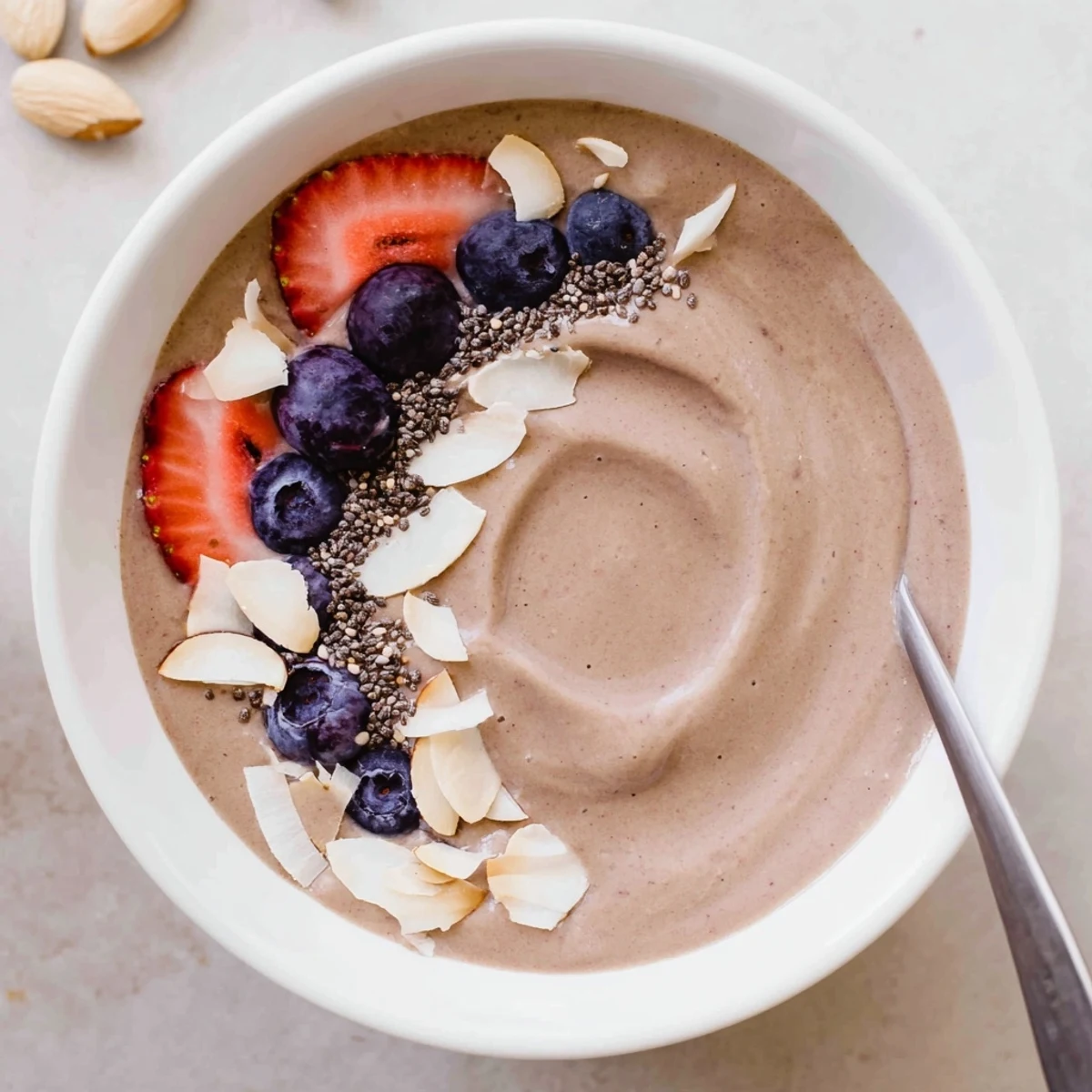 Bright tart-sweet Blueberry Strawberry Almond Smoothie Bowl with Coconut Flakes, ideal for breakfast.