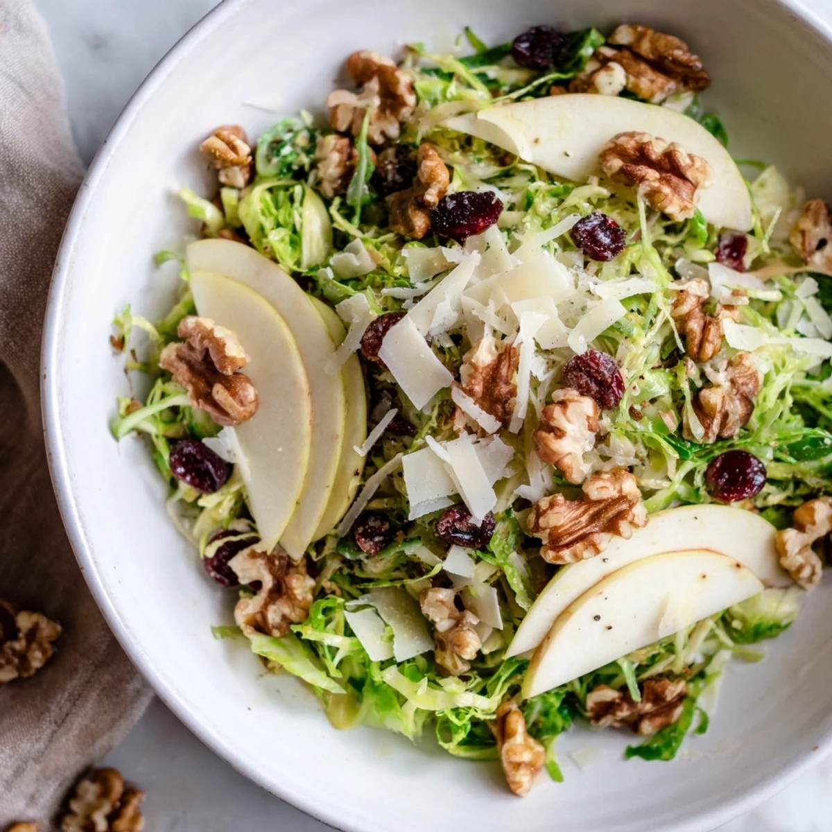 Shaved Brussels Sprout Apple Walnut Salad Bowl with Dijon Dressing, crunchy and bright