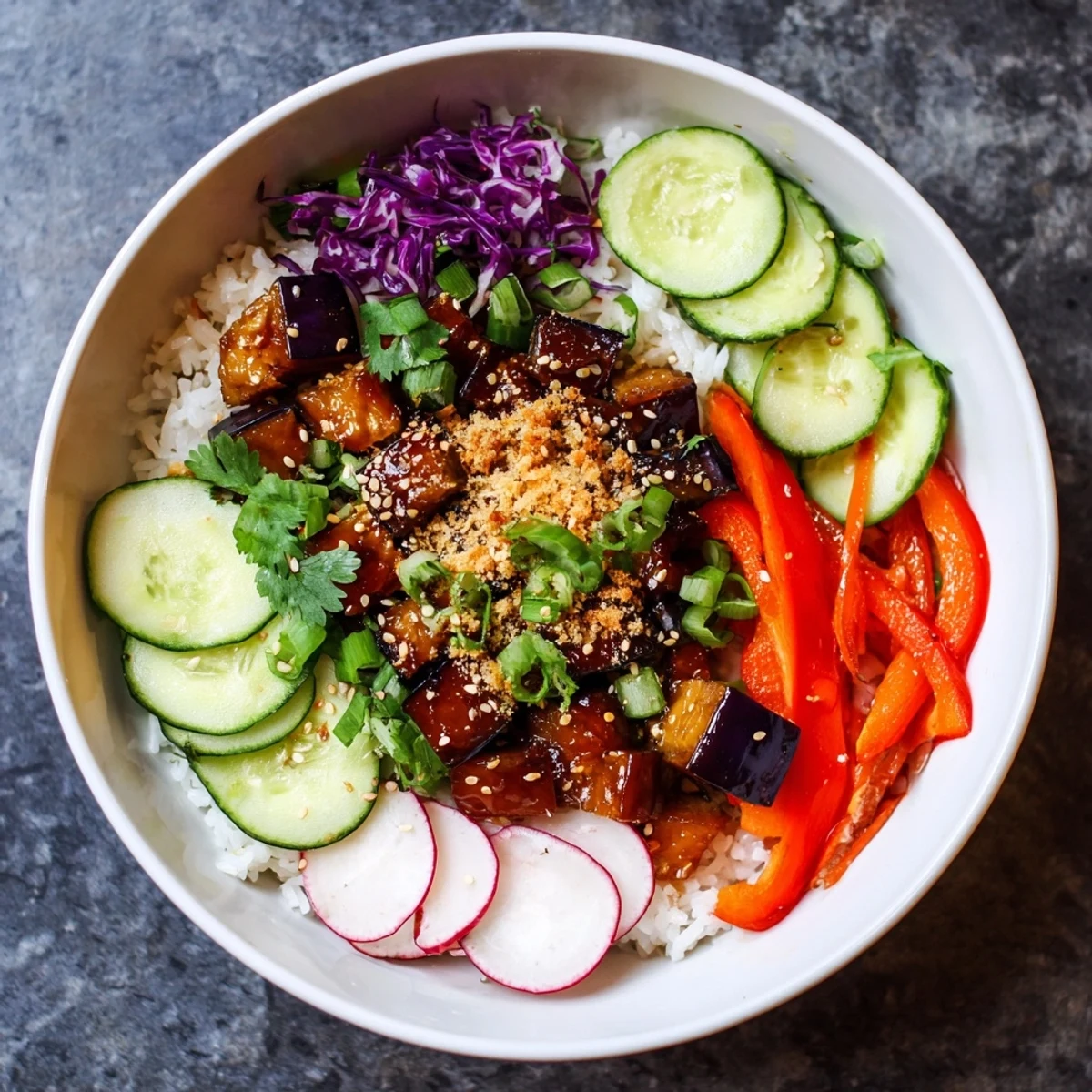 Golden roasted eggplant glazed in spicy gochujang served over fluffy rice with crisp vegetables and sesame crunch
