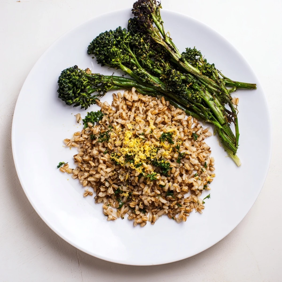 Golden garlic herb wild rice served alongside tender roasted broccolini with fresh parsley garnish