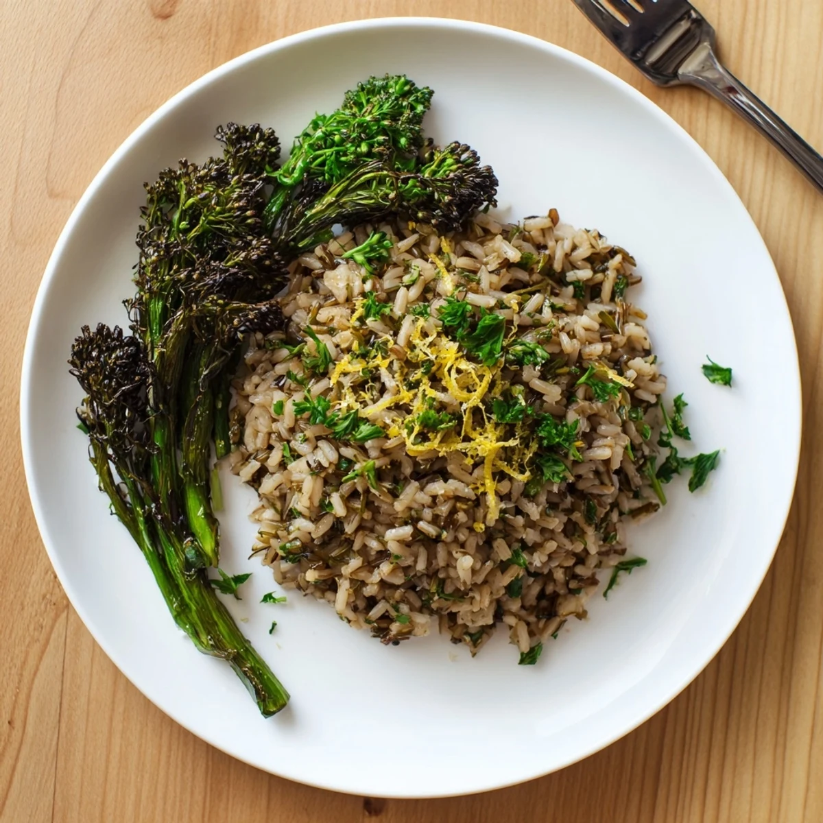Fluffy wild rice infused with aromatic garlic and herbs topped with lemon-zested broccolini