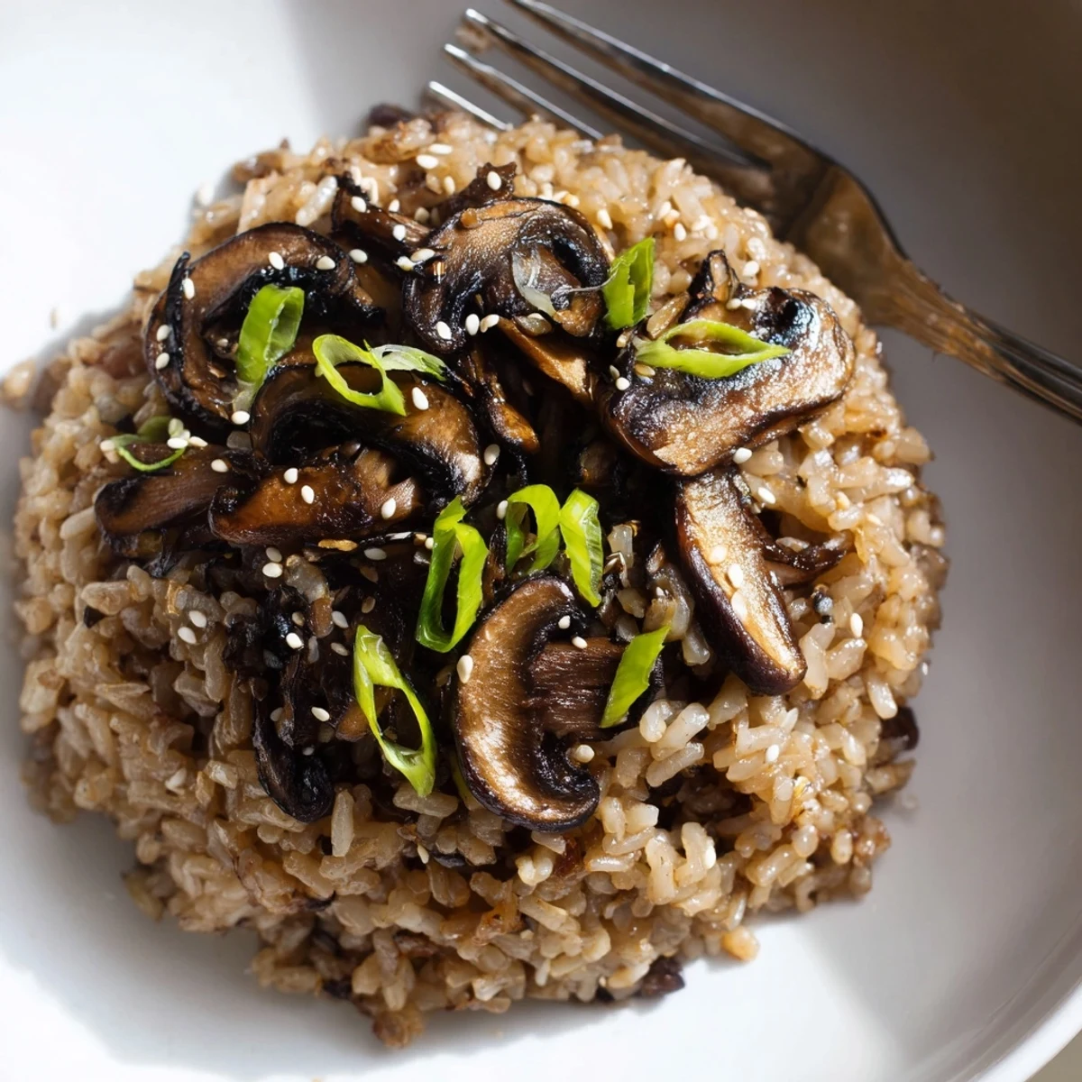 Smoky Garlic Ginger Brown Rice with Charred Mushrooms, scallions and sesame garnish
