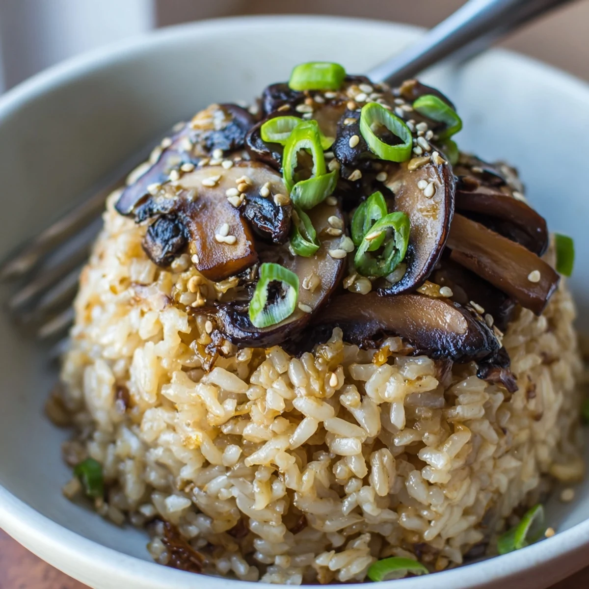 Hearty Garlic Ginger Brown Rice with Charred Mushrooms topped with toasted sesame