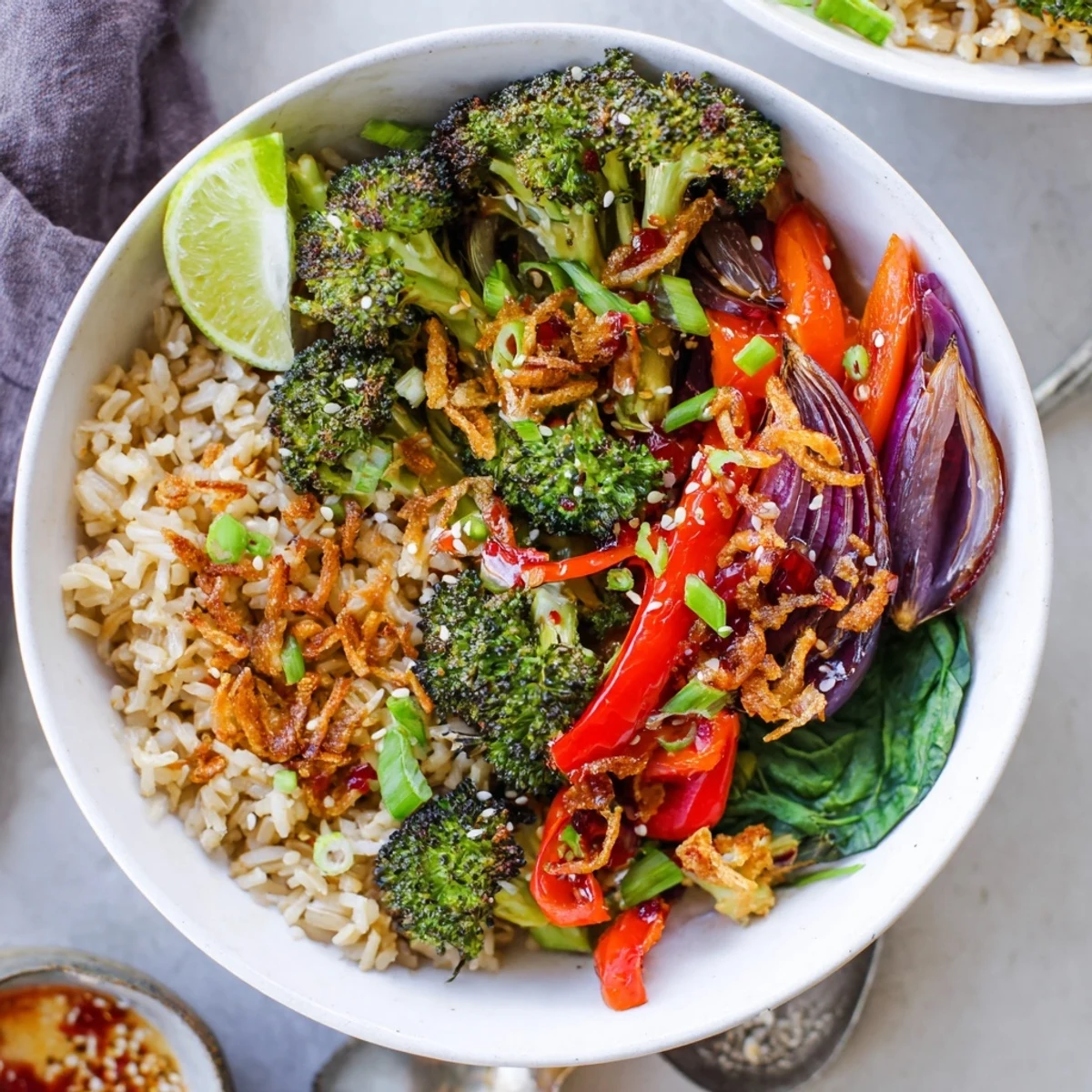 Vibrant spicy chili oil roasted broccoli veggie bowl served over tender quinoa