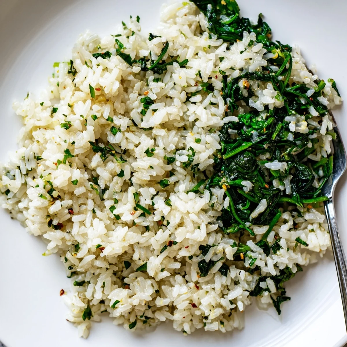 Garlic Herb Jasmine Rice with Sautéed Spinach served steaming in a white bowl