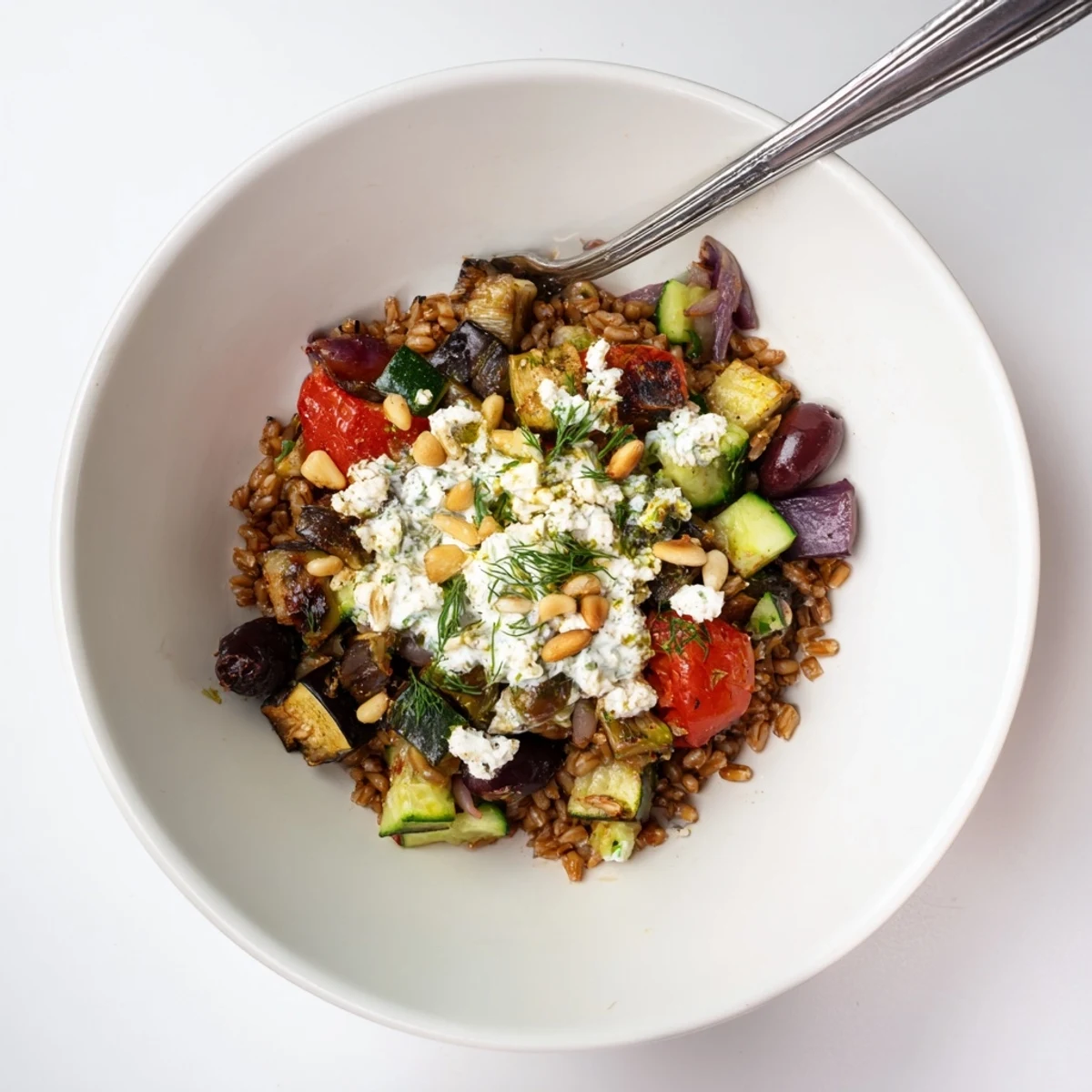 Golden caramelized eggplant and hearty farro nestled in a vibrant Mediterranean grain bowl