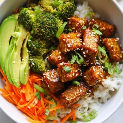 Caramelized tempeh cubes in a sticky maple soy Vegan Bowl with vibrant sesame broccoli