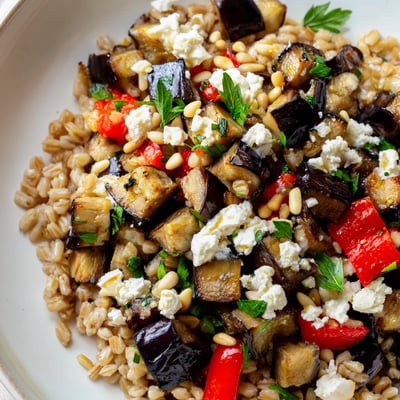 Hearty farro bowl featuring tender roasted eggplant, fresh veggies, and tangy feta.  